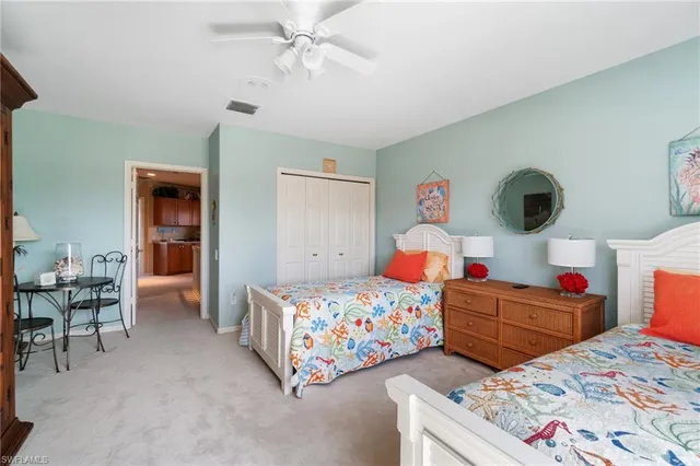 a bedroom with a bed table and a window
