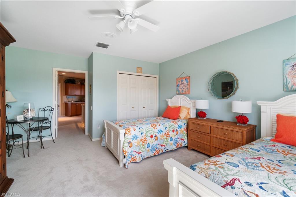 431 Palm Court Naples, FL 34108 - Photo 35 of 50 a bedroom with two beds and a chandelier