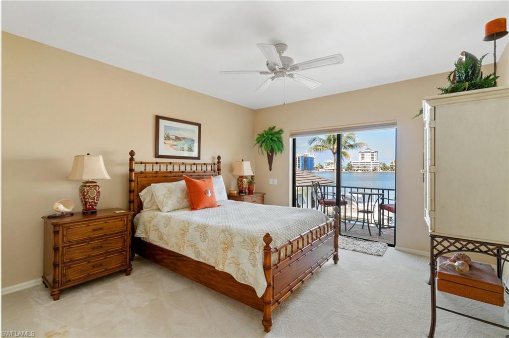 431 Palm Court Naples, FL 34108 - Photo 36 of 50 a bedroom with a bed table and a window