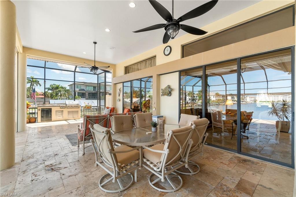 431 Palm Court Naples, FL 34108 - Photo 39 of 50 a view of a dining room with furniture wooden floor and chandelier