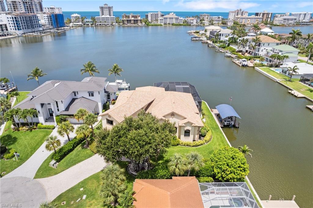 431 Palm Court Naples, FL 34108 - Photo 4 of 50 an aerial view of a house with a lake view