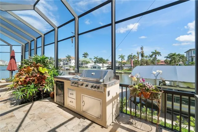 a kitchen with stainless steel appliances granite countertop a stove a sink and a cabinets