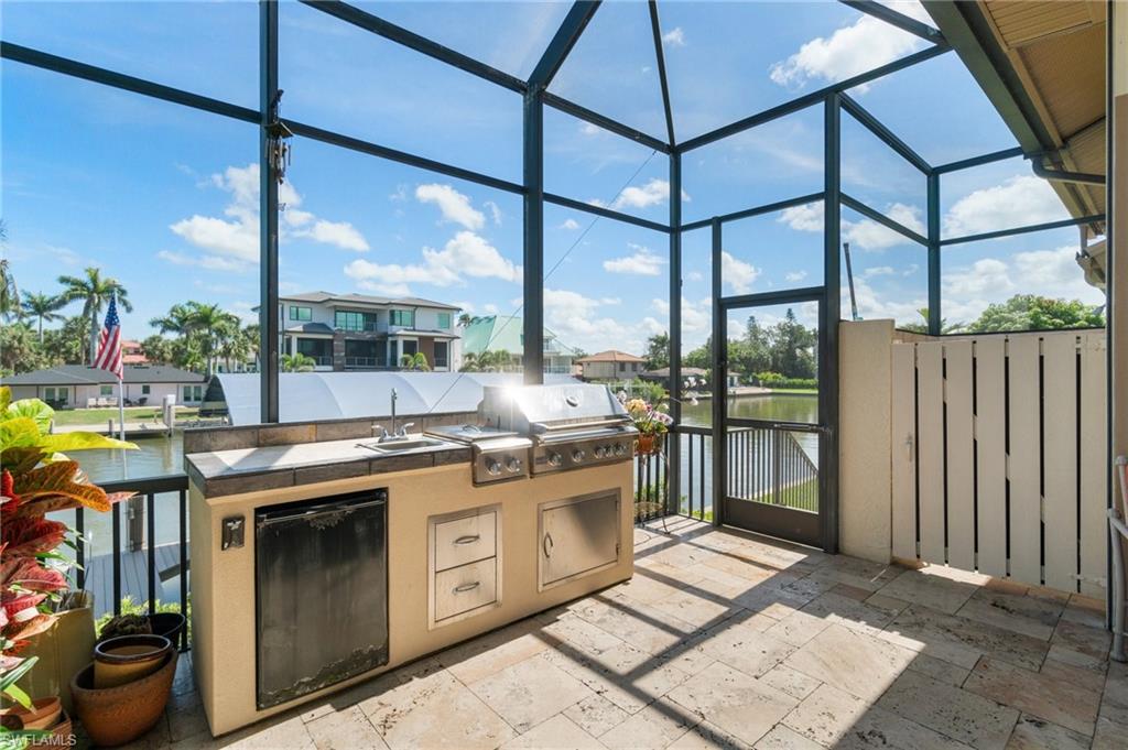 431 Palm Court Naples, FL 34108 - Photo 42 of 50 a kitchen with stainless steel appliances granite countertop a stove a sink and a cabinets