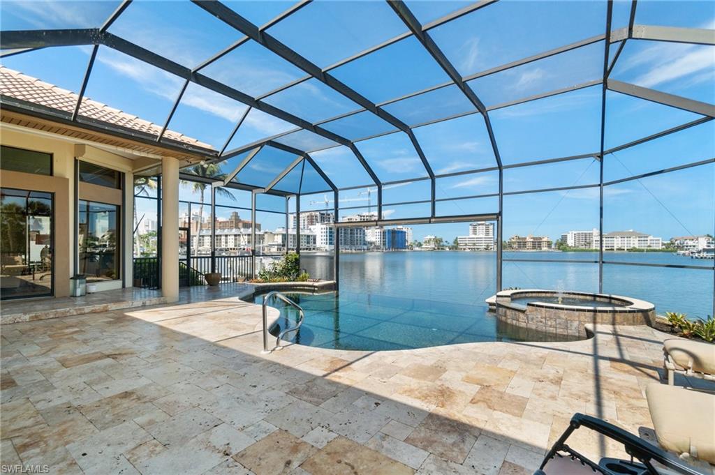 431 Palm Court Naples, FL 34108 - Photo 43 of 50 a patio with a table and chairs