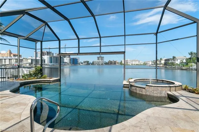 a view of a patio with chairs under an umbrella