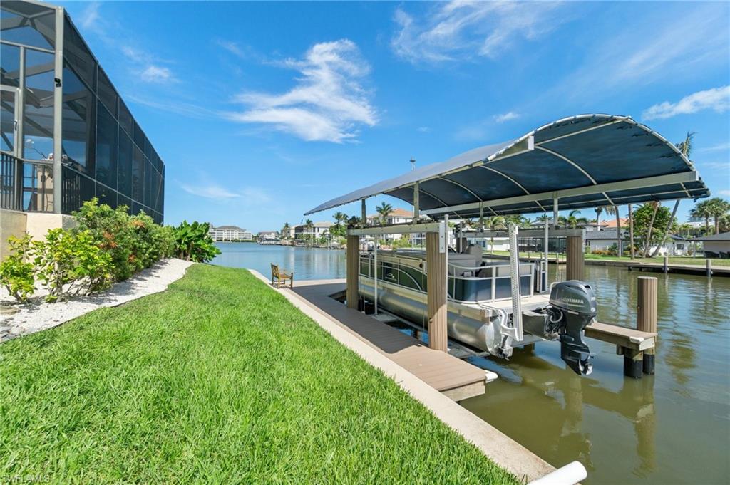 431 Palm Court Naples, FL 34108 - Photo 46 of 50 a view of a patio with chairs under an umbrella