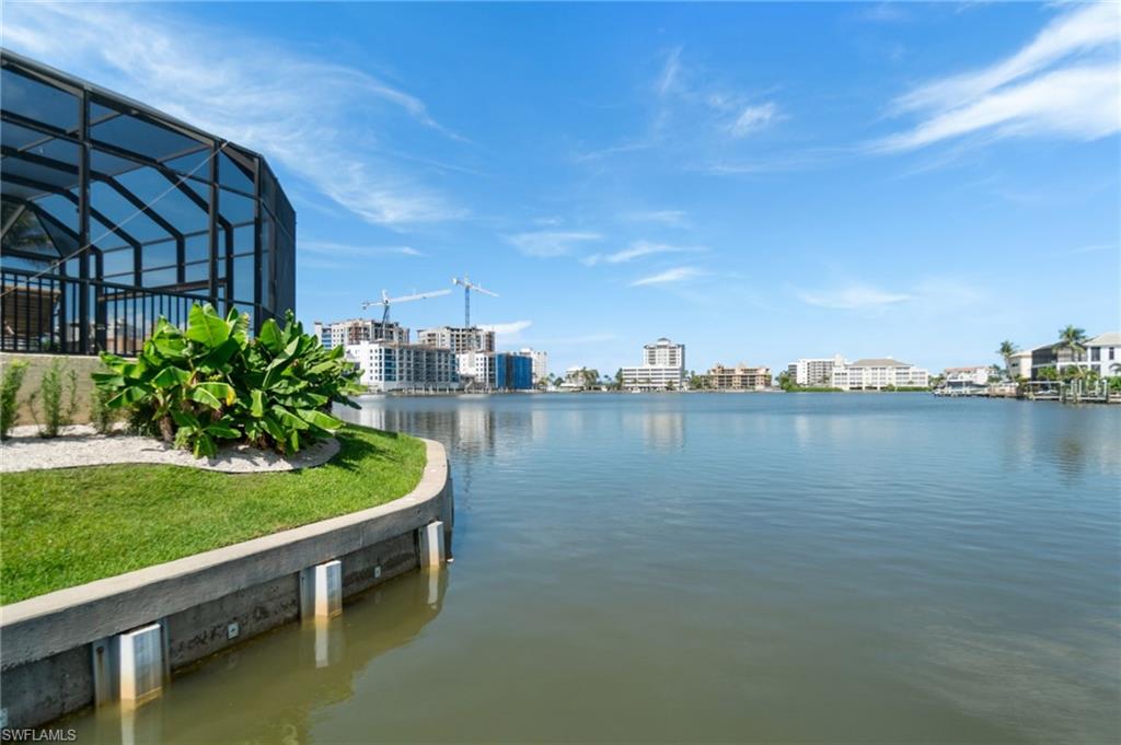 431 Palm Court Naples, FL 34108 - Photo 48 of 50 a view of a lake with a house in the background