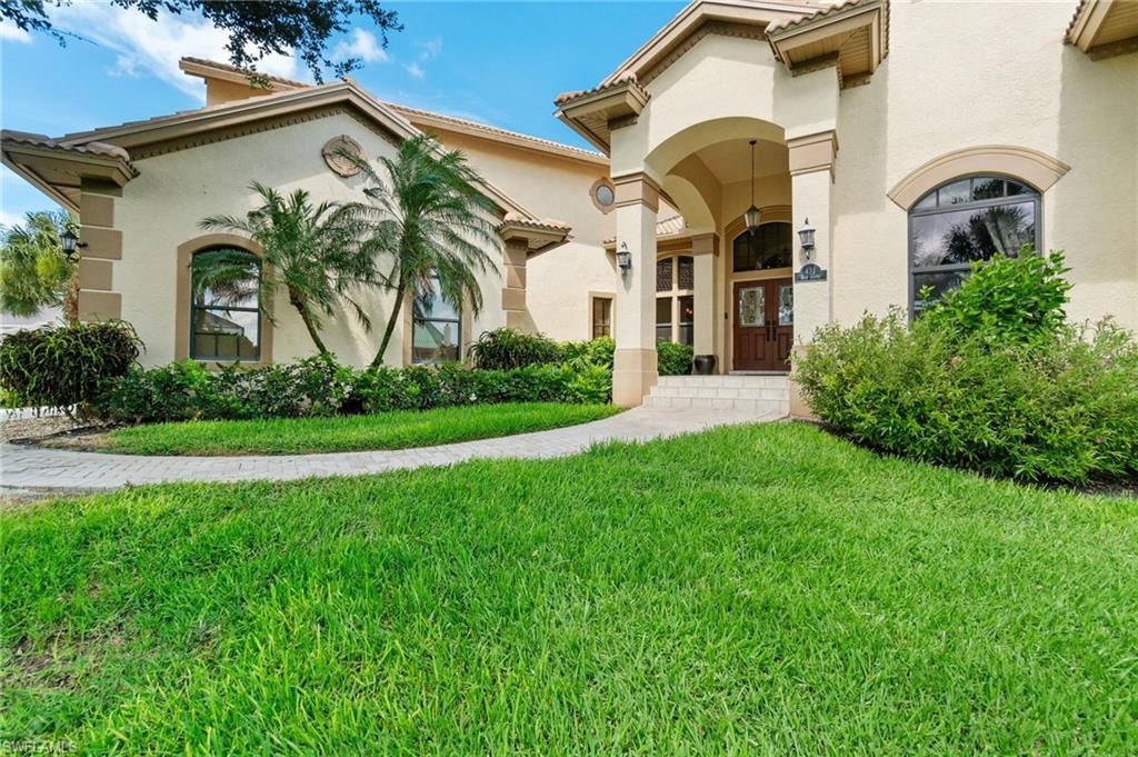431 Palm Court Naples, FL 34108 - Photo 49 of 50 a front view of a house with garden
