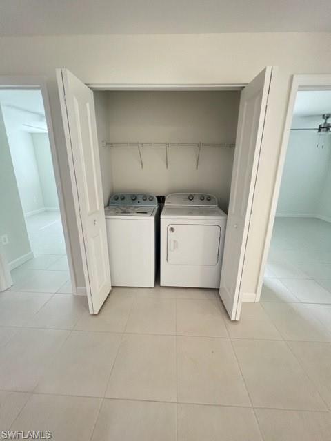 4414 Douglas Lane Lehigh Acres, FL 33973 - Photo 11 of 15 Laundry area featuring light tile patterned floors and independent washer and dryer