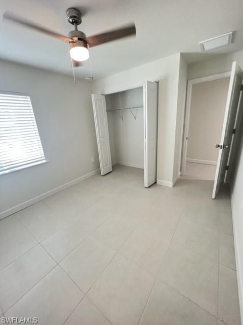 4414 Douglas Lane Lehigh Acres, FL 33973 - Photo 6 of 15 Unfurnished bedroom with ceiling fan, a closet, and light tile patterned floors