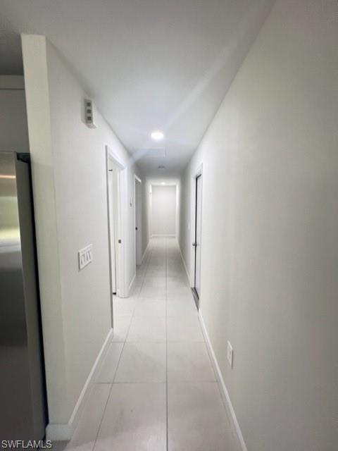 4414 Douglas Lane Lehigh Acres, FL 33973 - Photo 8 of 15 Hall with light tile patterned floors and baseboards