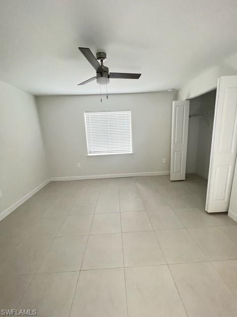 4414 Douglas Lane Lehigh Acres, FL 33973 - Photo 9 of 15 Unfurnished bedroom with light tile patterned floors, a closet, and ceiling fan