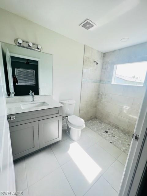 4414 Douglas Lane Lehigh Acres, FL 33973 - Photo 10 of 15 Full bathroom featuring vanity, a stall shower, and light tile patterned flooring