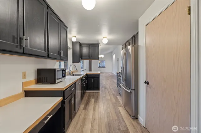 a kitchen with cabinets and stainless steel appliances