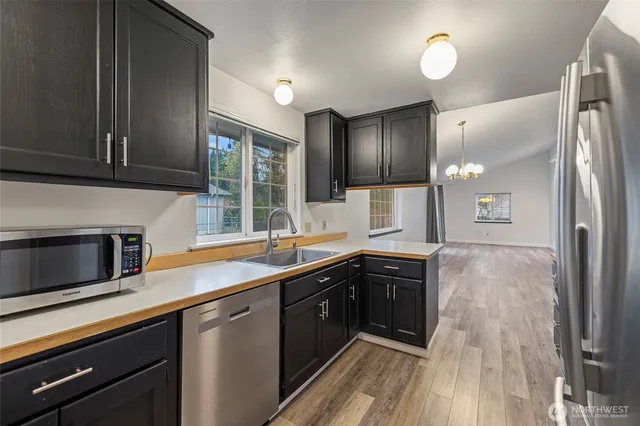 a kitchen with a sink and refrigerator