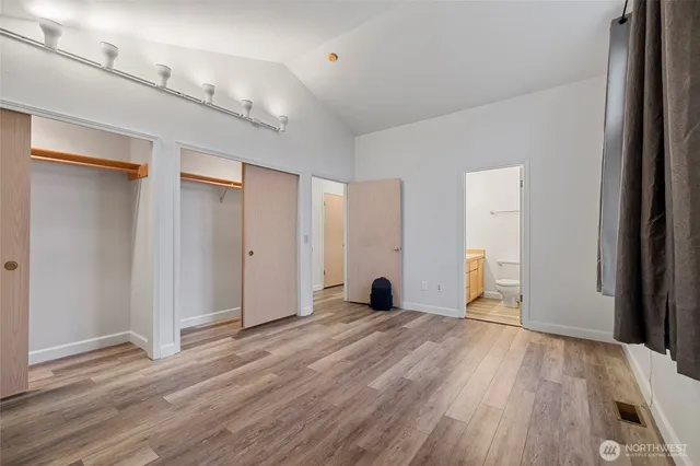 a view of empty room with wooden floor