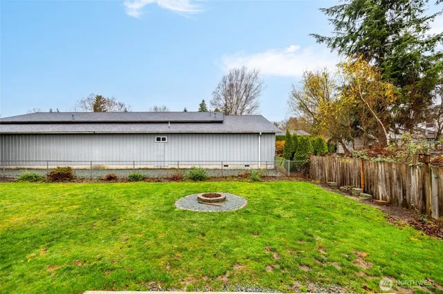 a view of a backyard with table and chairs