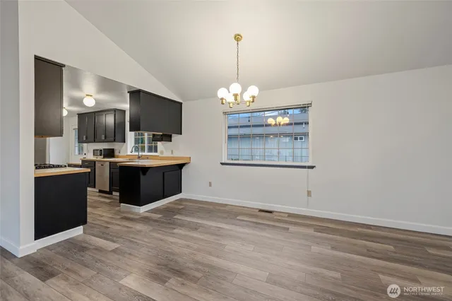 a view with a chandelier and wooden floor