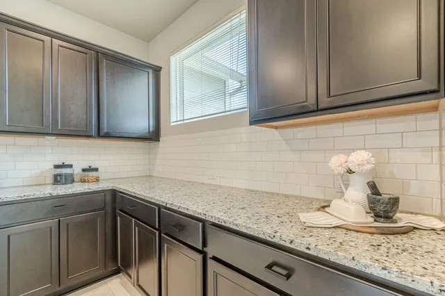 a kitchen with stainless steel appliances granite countertop a sink and cabinets