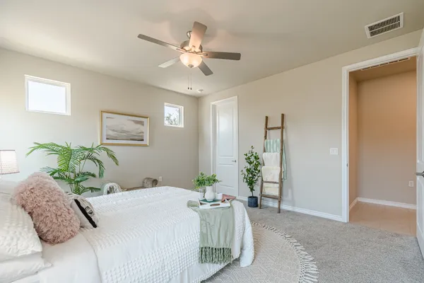 a bedroom with a large bed and a chandelier