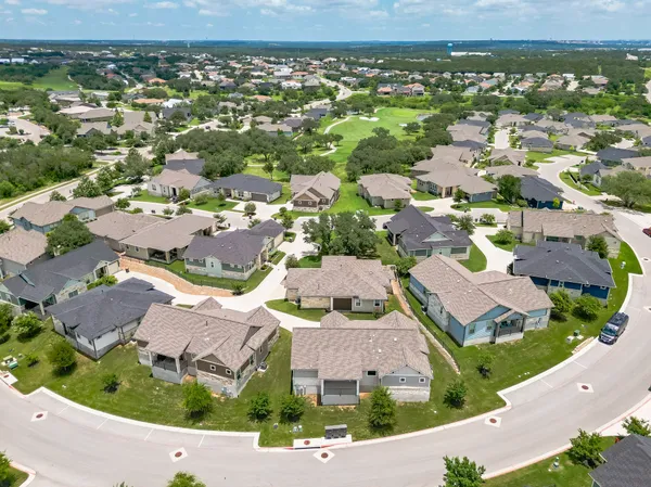 an aerial view of residential houses with outdoor space