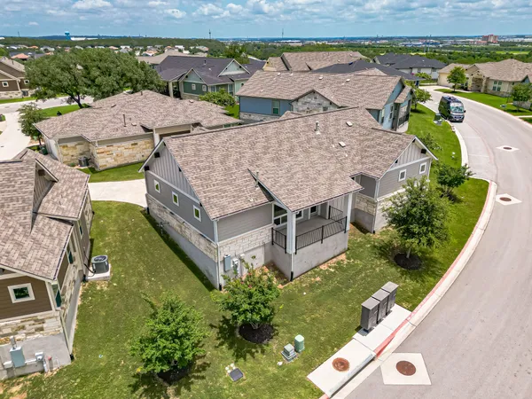 an aerial view of residential house with outdoor space and a lake view