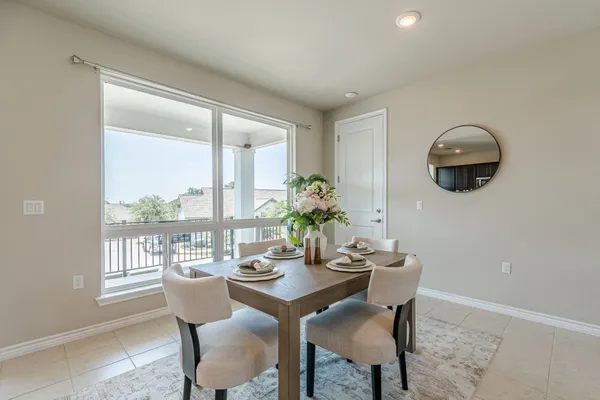 a dining room with furniture and window