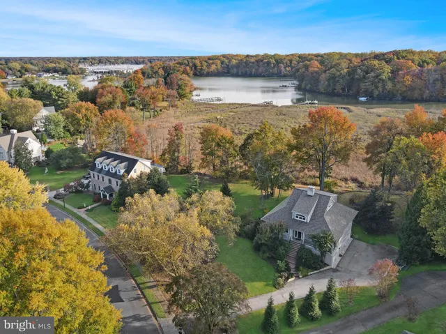 an aerial view of residential building with outdoor space and lake view