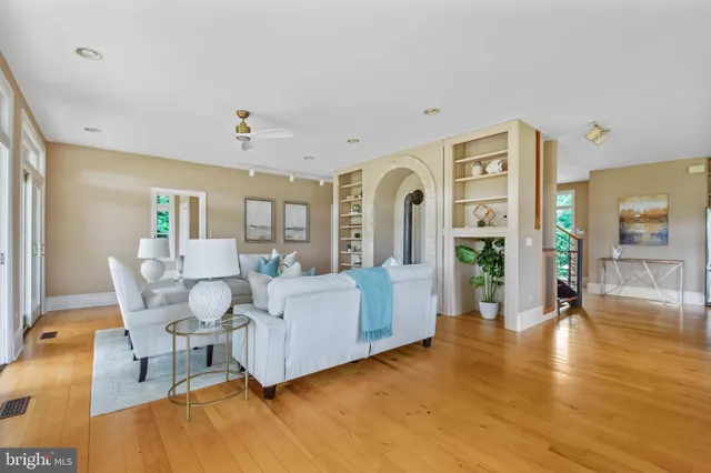 a living room with furniture fireplace and a large window