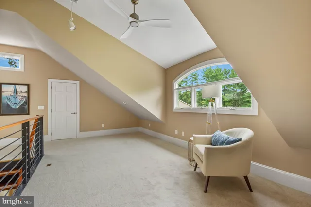 a bedroom with a bed a couch and a chandelier