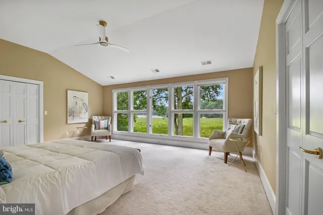 a bed room with a bed and a chair