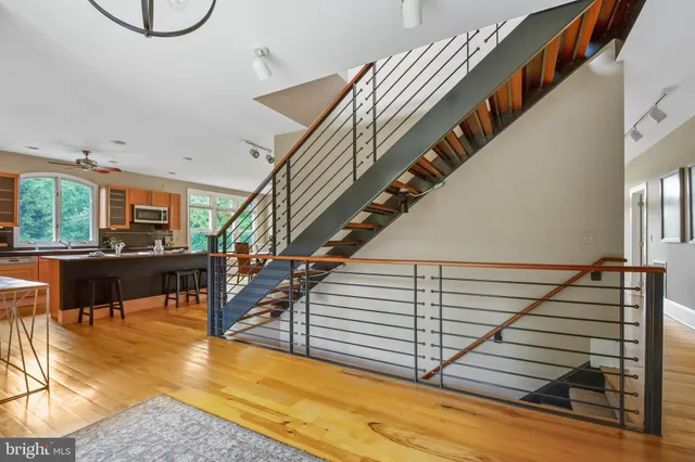 a view of entryway and hall with wooden floor