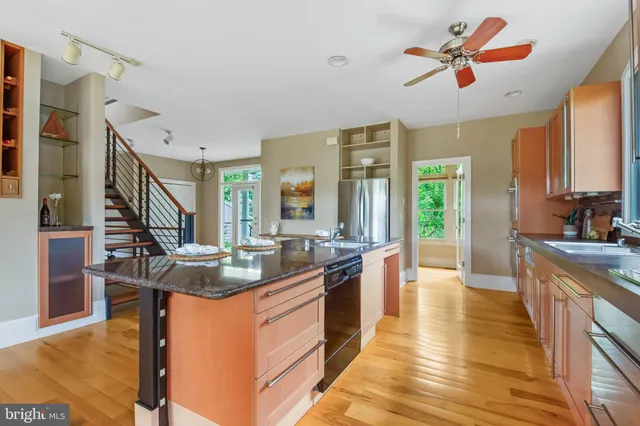 a view of a bedroom with wooden floor and windows