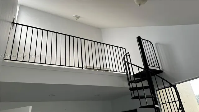 a view of staircase with lots of white walls