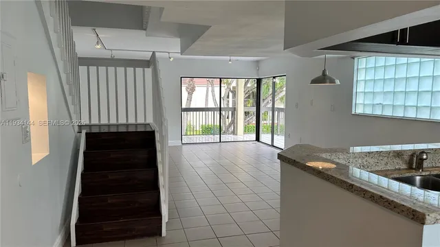 a kitchen with a sink a counter top space and cabinets