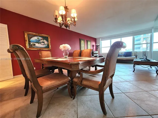a dining room with furniture and chandelier