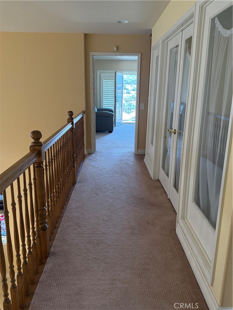 19823 Mariposa Pines Way Porter Ranch, CA 91326 - Photo 33 of 50 a view of a hallway with wooden floor and staircase