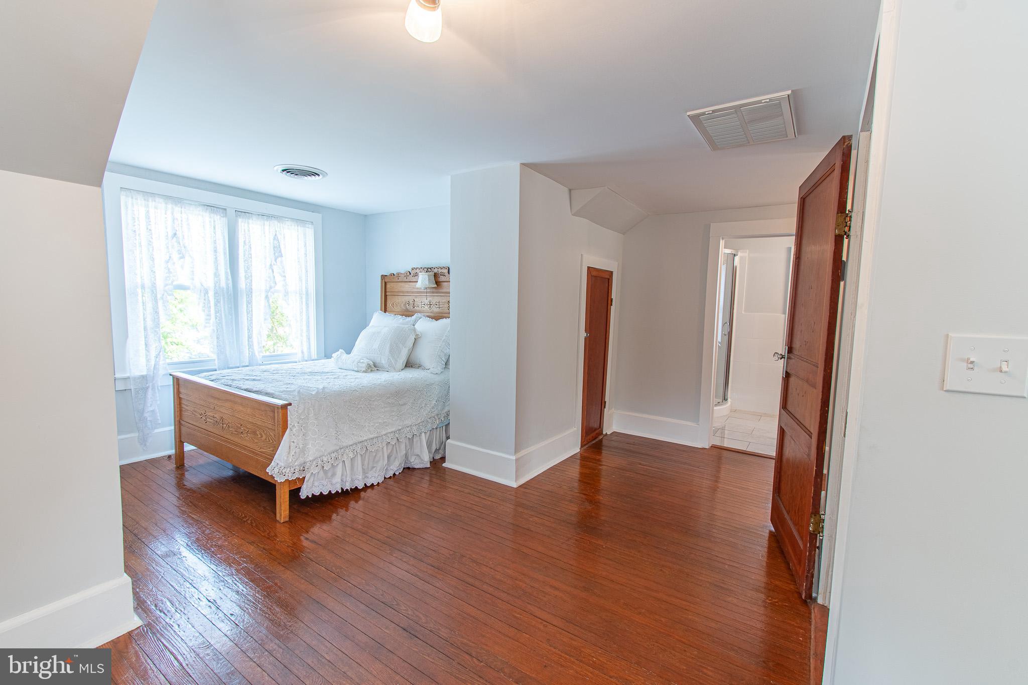 207 Crusader Road Cambridge, MD 21613 - Photo 46 of 76 a spacious bedroom with a bed and a dresser