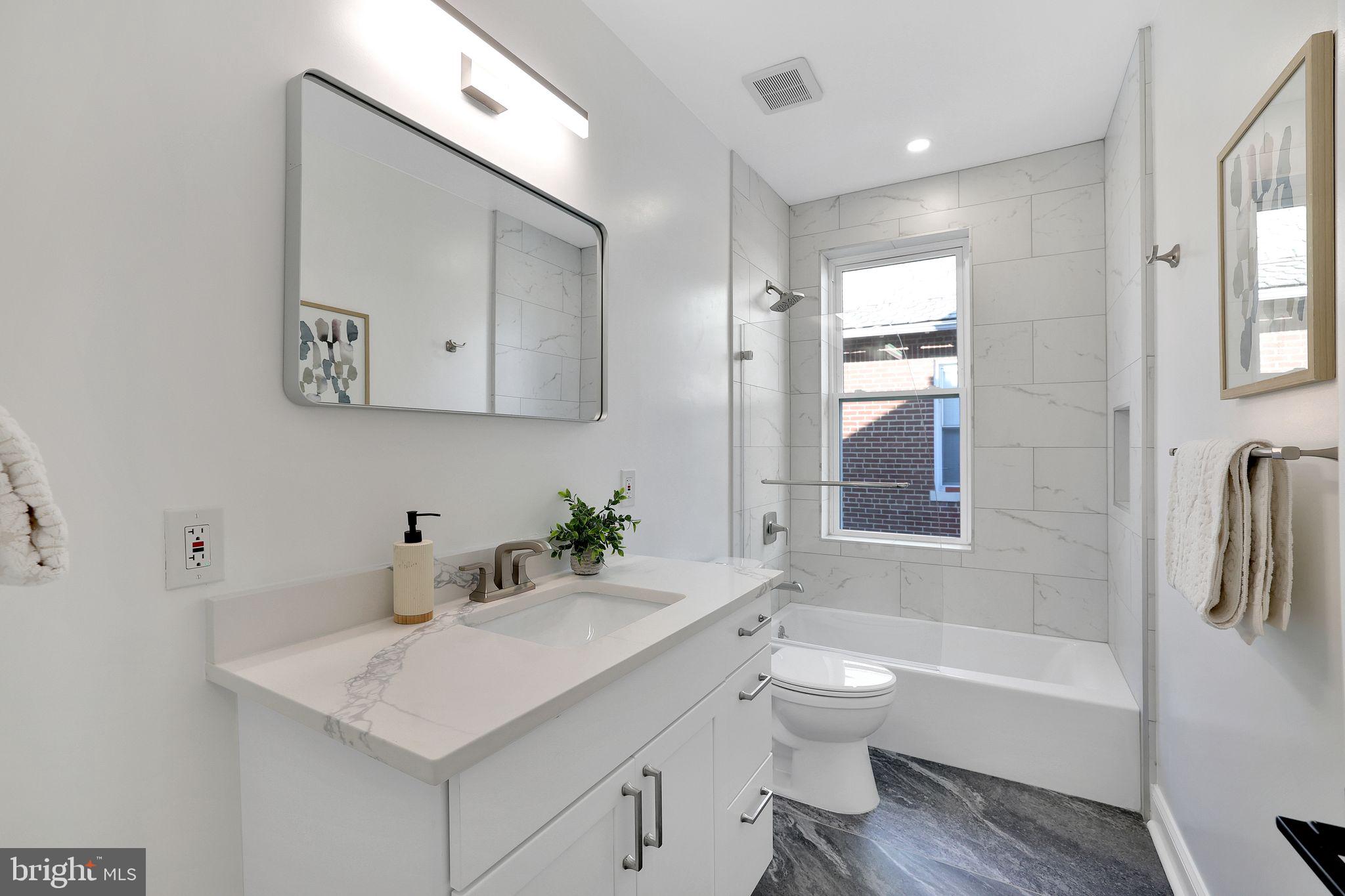 5803 5th Street Northwest Washington, DC 20011 - Photo 29 of 57 a bathroom with a sink a toilet and shower
