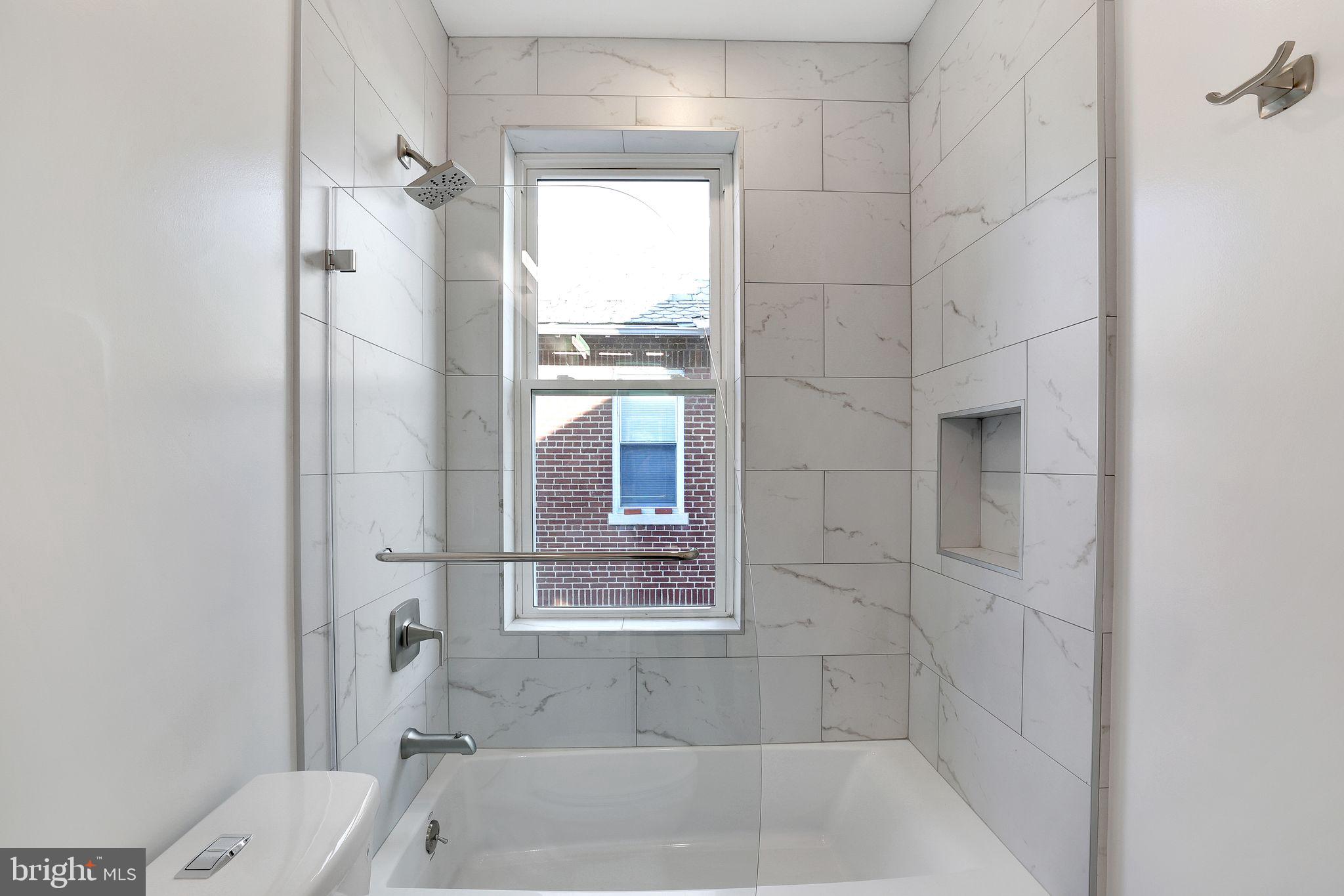 5803 5th Street Northwest Washington, DC 20011 - Photo 30 of 57 a bathroom with a tub and shower