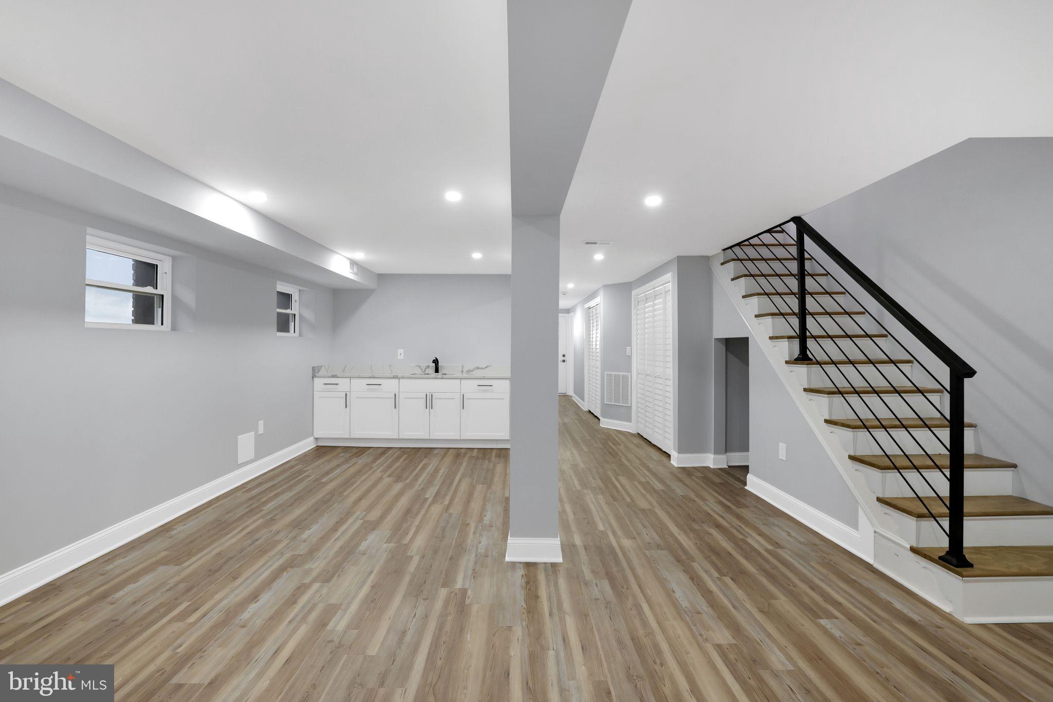 5803 5th Street Northwest Washington, DC 20011 - Photo 41 of 57 a view of an empty room with wooden floor and stairs