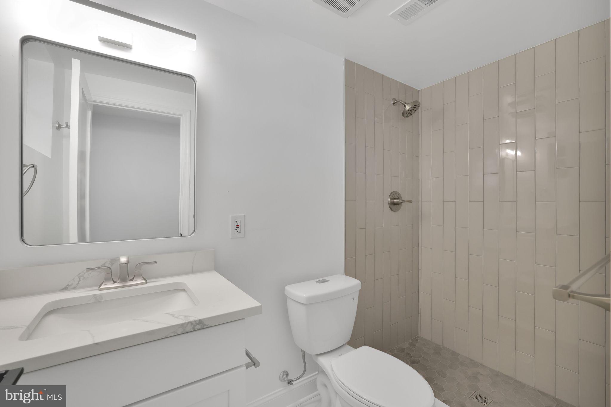 5803 5th Street Northwest Washington, DC 20011 - Photo 49 of 57 a bathroom with a sink toilet vanity and shower