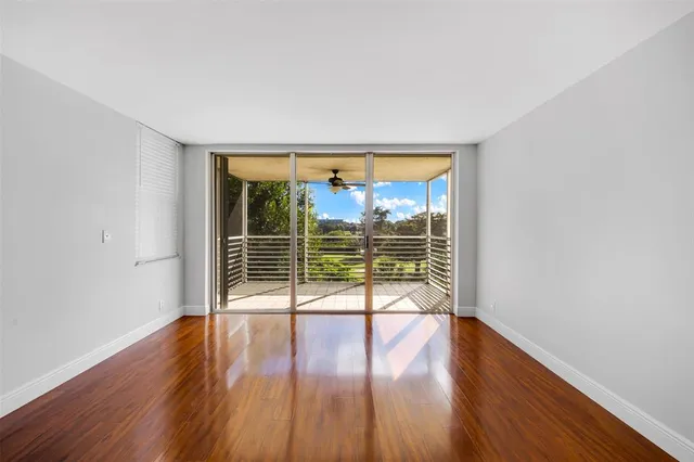 a view of wooden floor and windows in a room