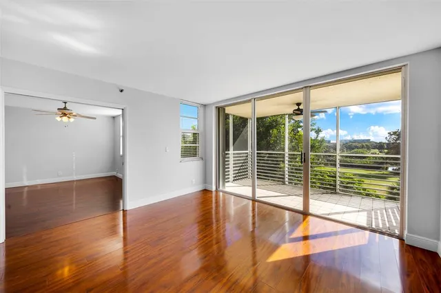 a view of a room with wooden floor and windows