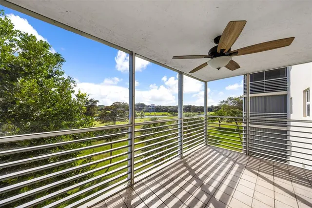 a view of a balcony with floor to ceiling windows with wooden floor
