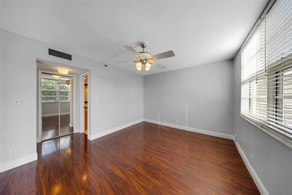 3520 Oaks Way, Unit 406 Pompano Beach, FL 33069 - Photo 19 of 32 wooden floor in an empty room with a window