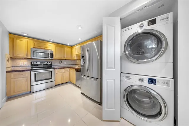 a kitchen with cabinets and stainless steel appliances