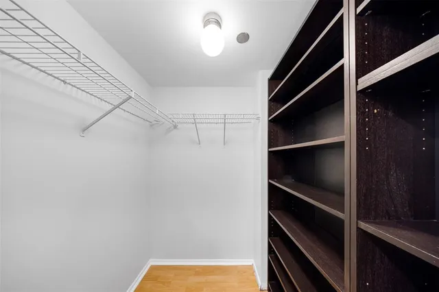 a bathroom with a granite countertop toilet sink and mirror