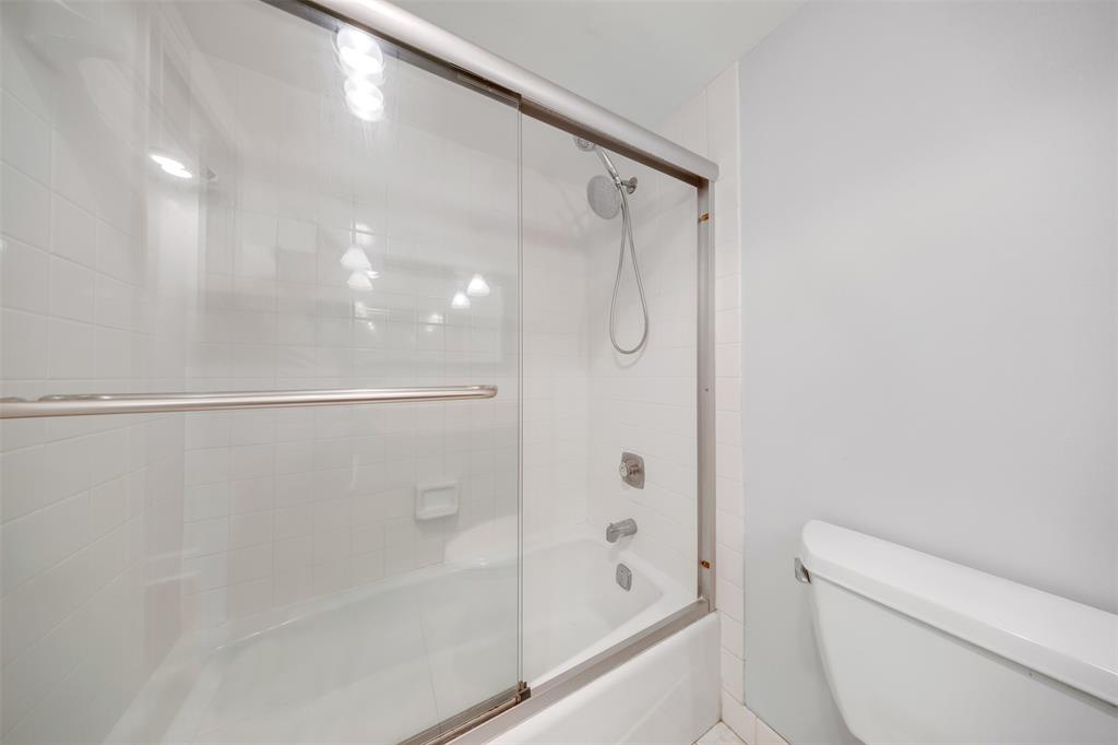 3520 Oaks Way, Unit 406 Pompano Beach, FL 33069 - Photo 28 of 32 a bathroom with a shower and a toilet