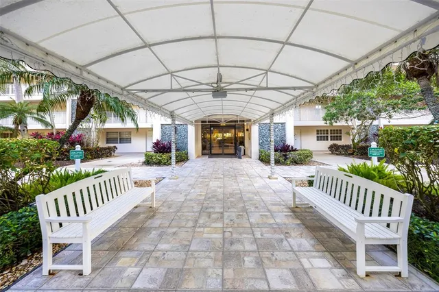 a view of a patio with table and chairs and potted plants